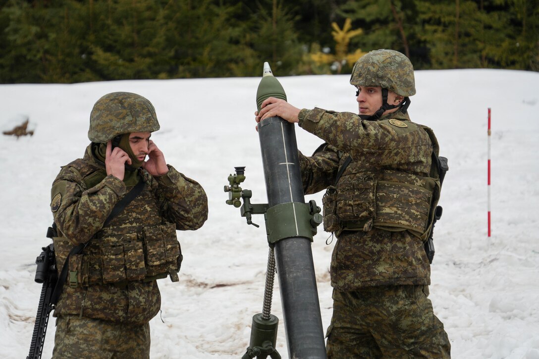 Members of the Kosovo Security Force load a mortar round during live fire training as part of command post exercise Dynamic Front at Grafenwoehr Training Area, Germany, Feb. 7, 2026.