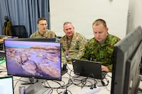 Maryland Air National Guard Lt. Col. Bob DeLuca, flight commander for the 175th Cyberspace Operations Squadron, Capt. James Bradford with the 276th Cyberspace Operations Squadron, and a member of the Estonian Defence Force, participate in Crossed Swords 25 in Tallinn, Estonia, Nov. 3, 2025.