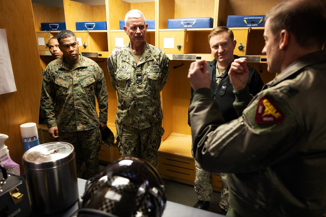 U.S. Marine Corps Col. David Merles of Marine Corps Support Facility Blount Island, Navy Capt. Craig Malloy of Navy Medicine Readiness and Training Command Jacksonville and Navy Capt. Bill Dull of Naval Submarine Base Kings Bay, listen as U.S. Air Force Col. David Siemion explains the helmet-mounted display of an F-35A Lightning II during a flightline tour Feb. 6, 2026, at Jacksonville Air National Guard Base, Florida. Siemion, a command pilot with combat experience in the F-15C, highlighted the aircraft’s controls and advances from prior generations. (Official Marine Corps photo by Dustin Senger)