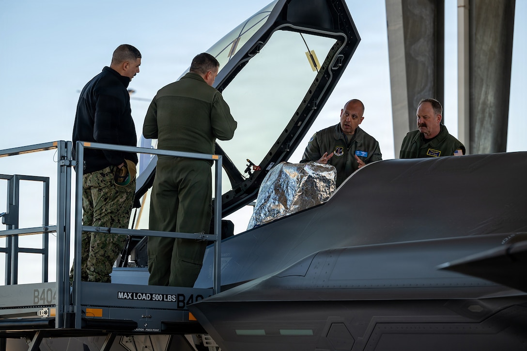 U.S. Air Force Col. Mansour Elhihi, center right, commander of the Florida Air National Guard’s 125th Fighter Wing, briefs U.S. Navy Master Chief Joseph Riley, left, command master chief, NAS Jacksonville, U.S. Navy Capt. Ryan Dexter, commanding officer, NAS Jacksonville, and U.S. Navy Capt. Mike Bukolt, right, executive officer, NAS Jacksonville, during a tour at Jacksonville Air National Guard Base, Florida, Feb. 6, 2026. Inviting Jacksonville’s military leaders from Blount Island Command, Naval Air Station Jacksonville, Naval Submarine Base Kings Bay, Naval Station Mayport, and Navy Medical Readiness and Training Command to the Florida Air National Guard’s 125th Fighter Wing for a briefing on its missions and F-35A Lightning II aircraft fosters inter-service partnerships and strengthens relationships with the local military community. (U.S. Air National Guard photo by Tech. Sgt. Marissa Welker)