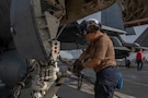 U.S. Navy Aviation Boatswain’s Mate (Handling) Airman Angelica Ramirez removes chains from an F/A-18F Super Hornet, attached to Strike Fighter Squadron (VFA) 41, on the flight deck of Nimitz-class aircraft carrier USS Abraham Lincoln (CVN 72) in the Arabian Sea, Feb. 4, 2026. Abraham Lincoln is deployed to the U.S. 5th Fleet area of operations to support maritime security and stability in the U.S. Central Command area of responsibility. (U.S. Navy photo by Mass Communication Specialist Seaman Apprentice Cesar Zavala)