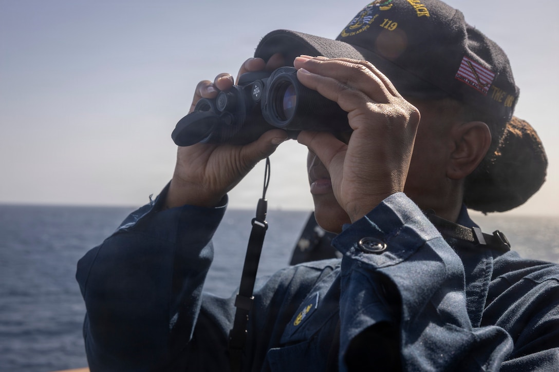 U.S. Navy Chief Quartermaster Katisha Ross, assigned to Arleigh Burke-class guided-missile destroyer USS Delbert D. Black (DDG 119), looks through binoculars during a scheduled routine port visit to Jeddah, Saudi Arabia, Feb. 4, 2026. Delbert D. Black is deployed to the U.S. 5th Fleet area of operations to support maritime security and stability in the U.S. Central Command area of responsibility. (U.S. Navy photo by Mass Communication Specialist 1st Class Wendy Arauz)