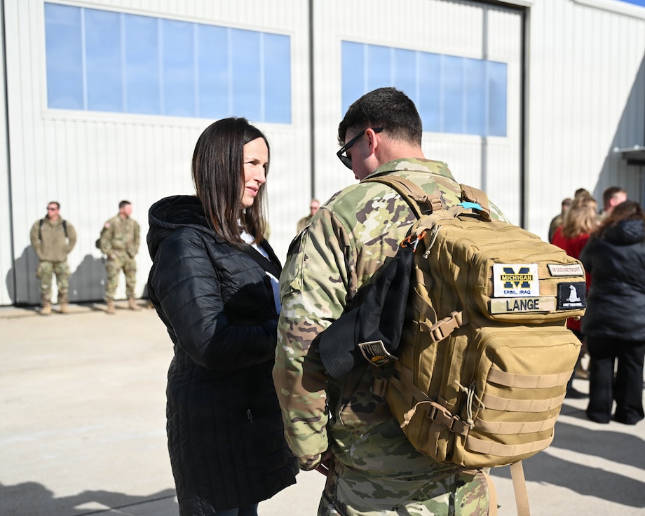 Illinois Army National Guard Sgt. Owen Lange talks with his mother, Anne Lange, after returning from deployment.