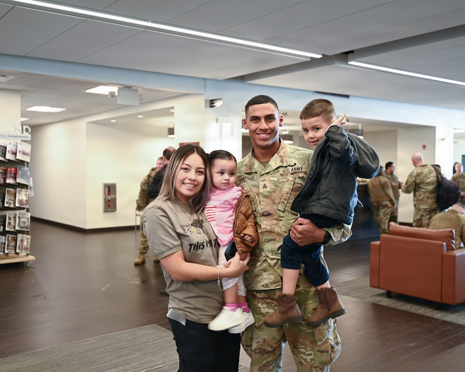 Illinois Army National Guard Sgt. Diego Santiago poses for a family photo with his 3-year-old son, Jacob Santiago, 1-year-old daughter, Juliette Santiago, and his partner and the children’s mother, Brendy Paz.