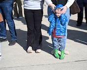 Three-year-old Maverick Ricketts holds his ears in the cold as the airplane carrying his father, Illinois Army National Guard Cpl. Briar Ricketts, lands in Springfield.
