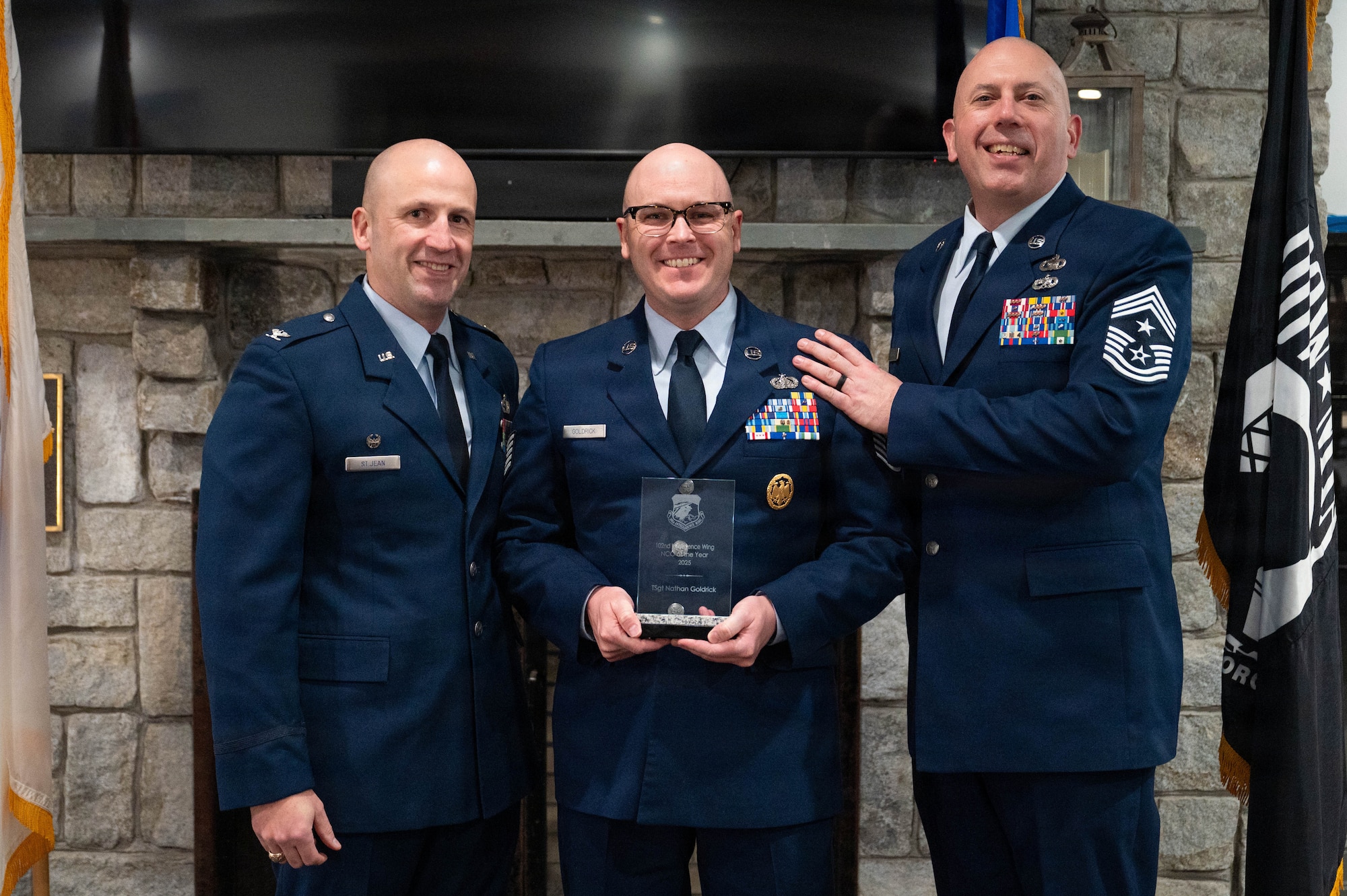 Airmen pose with an award.