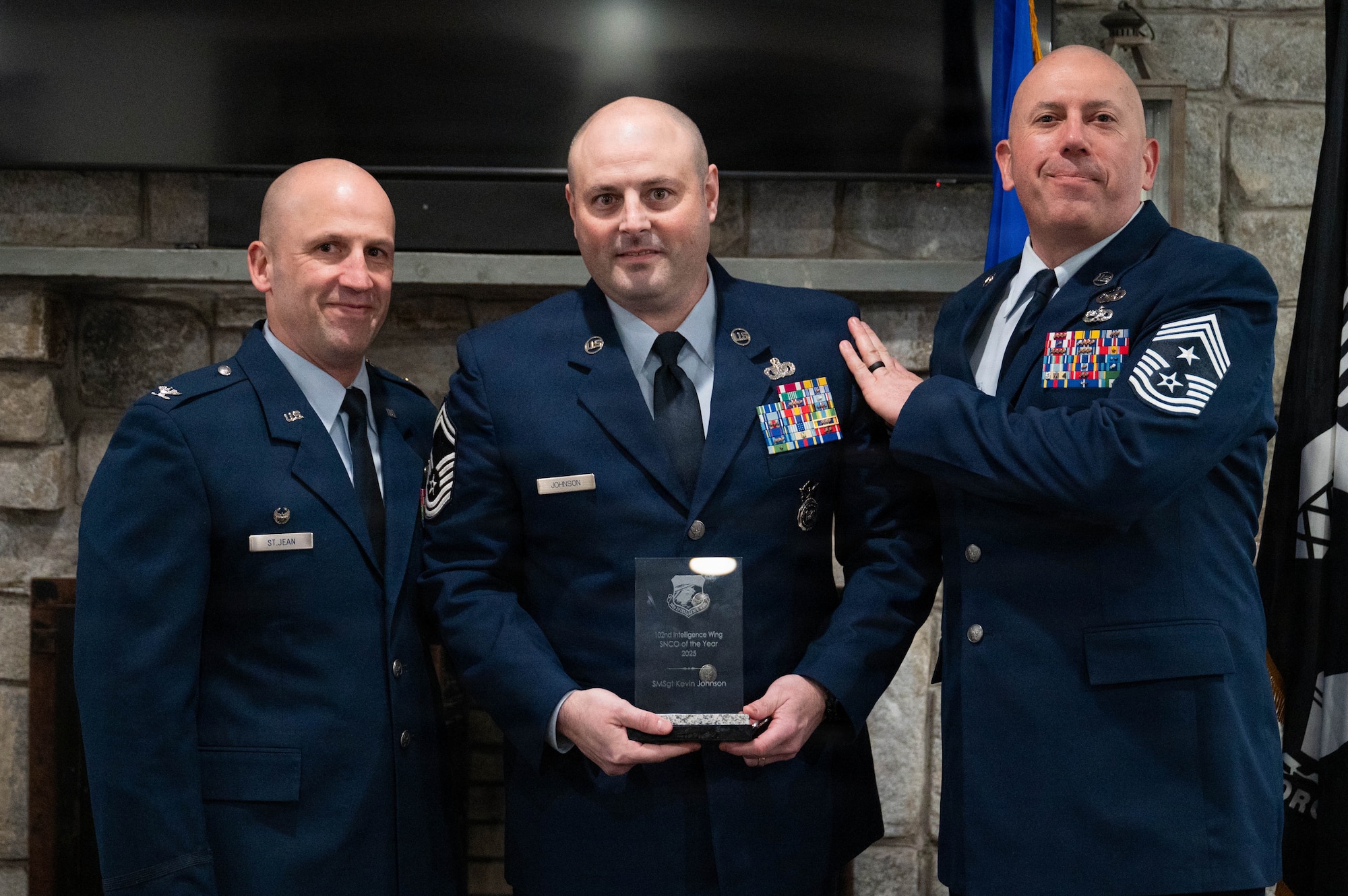 Airmen pose with an award.