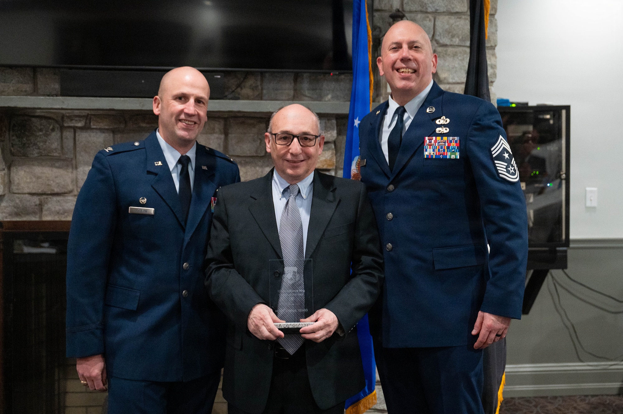Airmen pose with an award.