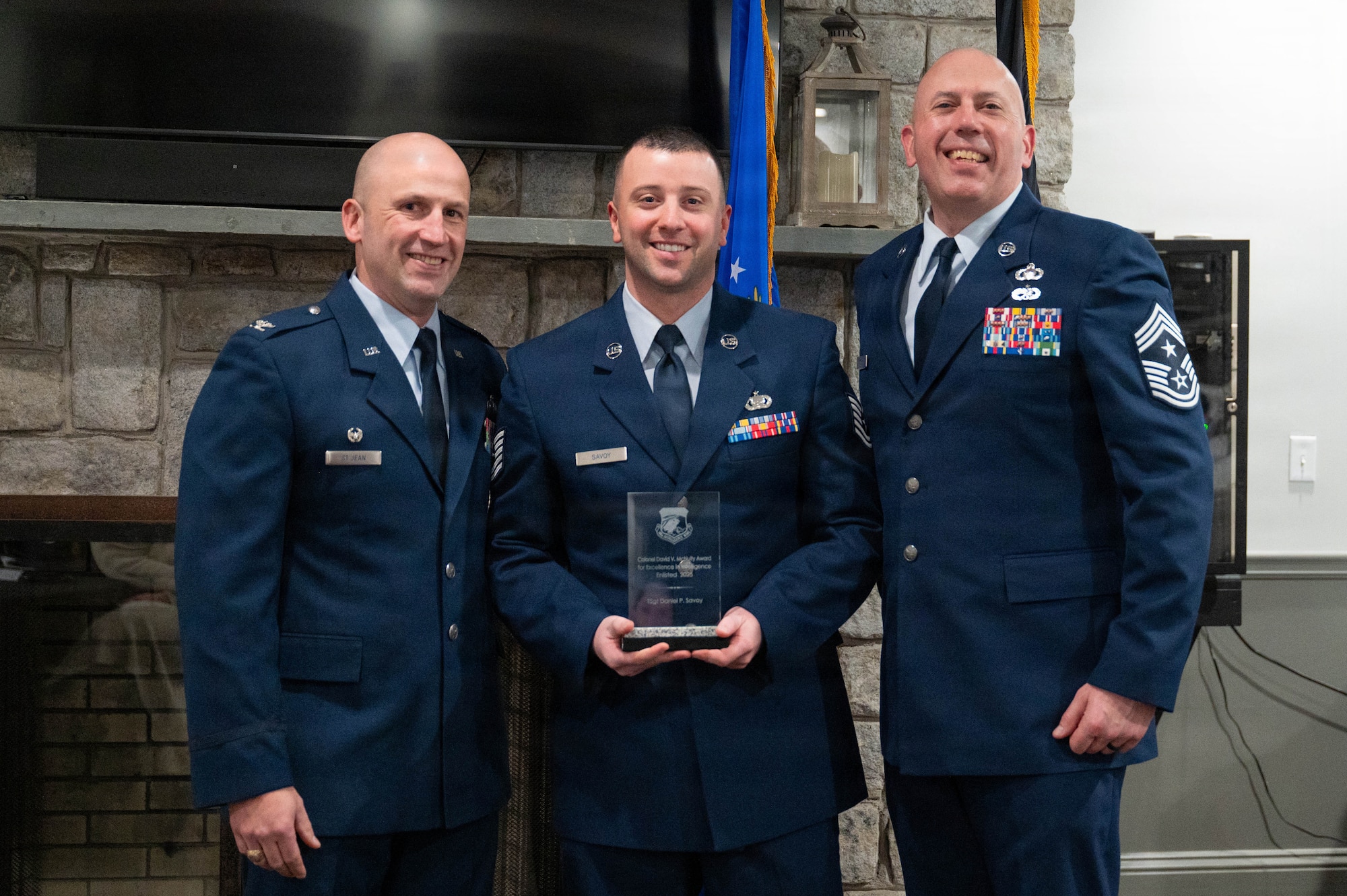 Airmen pose with an award.