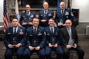 Airmen pose with an award.