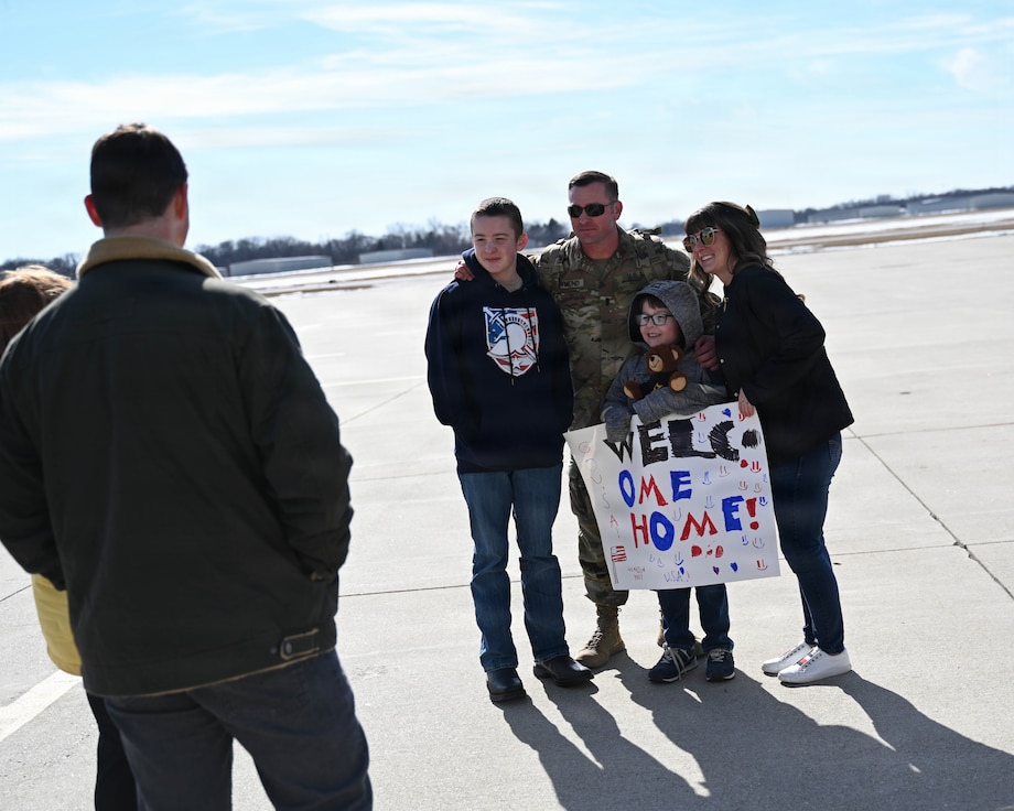 Illinois Army National Guard 1st Lt. Michael Raymond poses for a picture with his family.