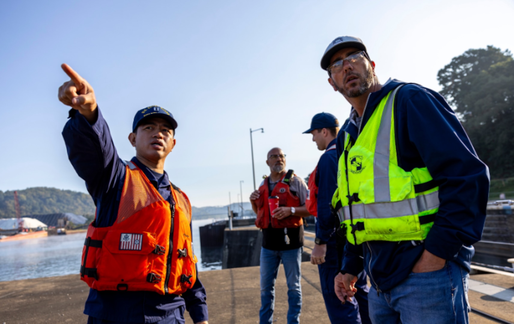 LT Gay lord Amores, with the U.S. Coast Guard, talks with Alan Nogy, the U.S. Army Corps of Engineers Pittsburgh District chief of the locks and dams branch, while waiting for the first commercial towboat to navigate through the newly-opened channel at Monongahela River Locks and Dam 3 in Elizabeth, Pennsylvania, Sept. 5, 2024.  (U.S. Army Corps of Engineers Pittsburgh District photo by Michel Sauret)