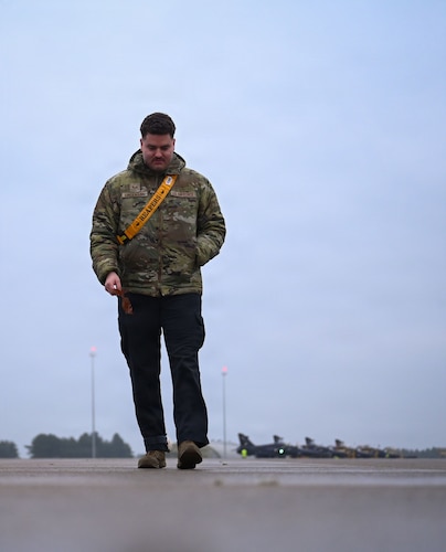 U.S. Air Force Staff Sgt. Gunnar Lindemann, 493rd Fighter Generation Squadron weapons load crew chief, conducts a foreign object debris walk.