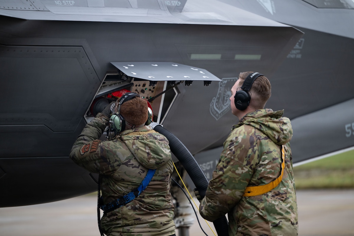 U.S. Air Force Airman 1st Class Logan Gillmer, 492nd Fighter Generation Squadron avionics technician, and Staff Sgt. Evan Schneider, 493rd FGS dedicated crew chief, conduct hot-pit operations on an F-35A Lightning II aircraft.