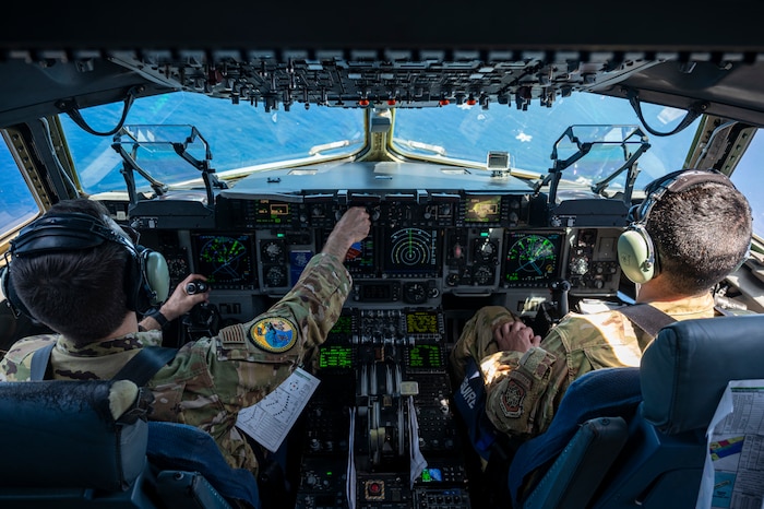 U.S. Air Force Lt. Col Matthew Eggert, 6th Airlift Squadron commander, left, and Maj. Andrew Quallio, 6AS C-17 Globemaster III pilot, right, pilot a U.S. Air Force C-17 Globemaster III alongside USAF, U.S. Navy, Japan Air Self-Defense Force aircraft in a formation over the Pacific Ocean in support of Valiant Shield 2024, June 7, 2024. Exercises such as Valiant Shield allow the Indo-Pacific Command Joint Forces the opportunity to integrate forces from all branches of service and with our allies to conduct precise, lethal, and overwhelming multi-axis, multi-domain effects that demonstrate the strength and versatility of the Joint Force and our commitment to a free and open Indo-Pacific. (U.S. Air Force photo by Senior Airman Keegan Putman)