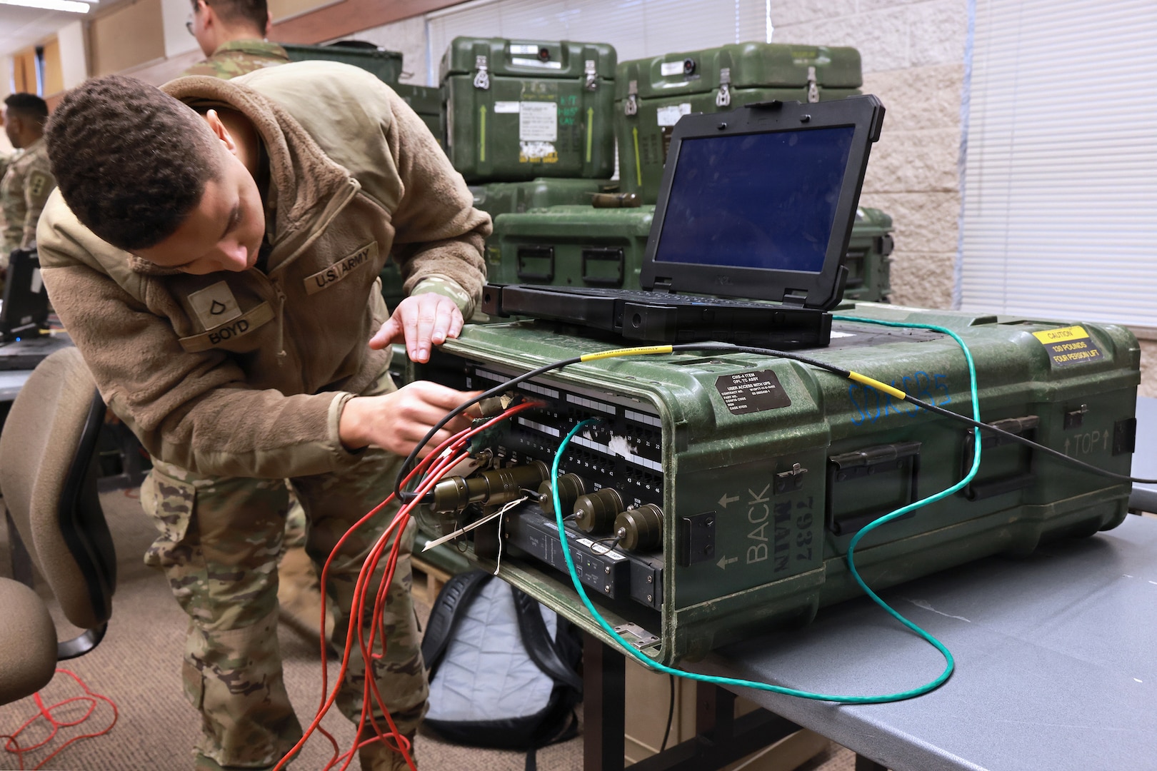 U.S. Army Pfc. Preston Boyd, an information technology specialist with the 1st Squadron, 105th Cavalry Regiment, Wisconsin Army National Guard, connects to a command post node switcher during a combined signal exercise at Camp Douglas in Central Wisconsin, Jan. 31, 2026.