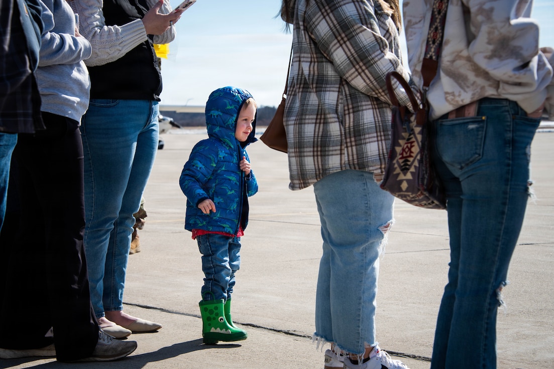 Three-year-old Maverick Ricketts looks across the tarmac for his father, Cpl. Briar Ricketts.