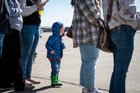 Three-year-old Maverick Ricketts looks across the tarmac for his father, Cpl. Briar Ricketts.