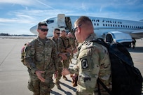 Illinois Army National Guard soldiers exit the plane after arriving home from a deployment.