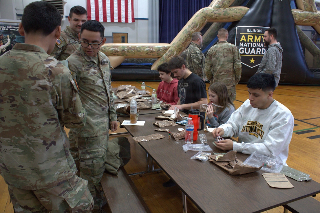 Members of the Ensign family(center) try a meal, ready-to-eat for lunch at the Sycamore Armory on February 7, 2026.