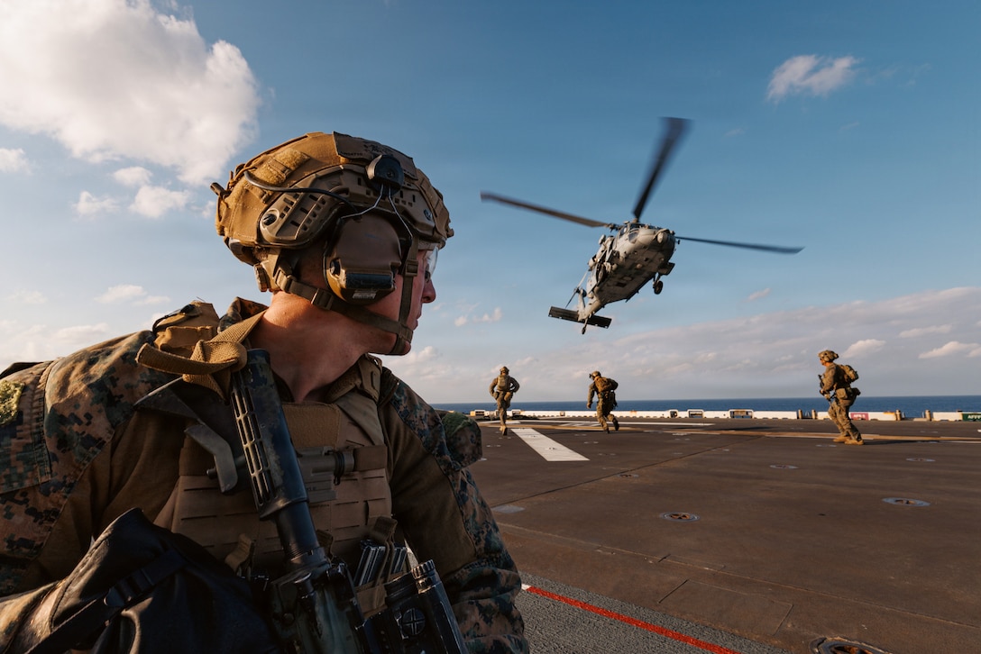 U.S. Marines with Maritime Raid Force, 31st Marine Expeditionary Unit, fast rope off of an MH-60S Knighthawk assigned to Helicopter Sea Combat (HSC) Squadron 25, in the Philippine Sea, Jan. 30, 2026. Marines and Sailors conducted fast-rope training to enhance air-to-ground insertion capabilities for operations in support of the 31st MEU.