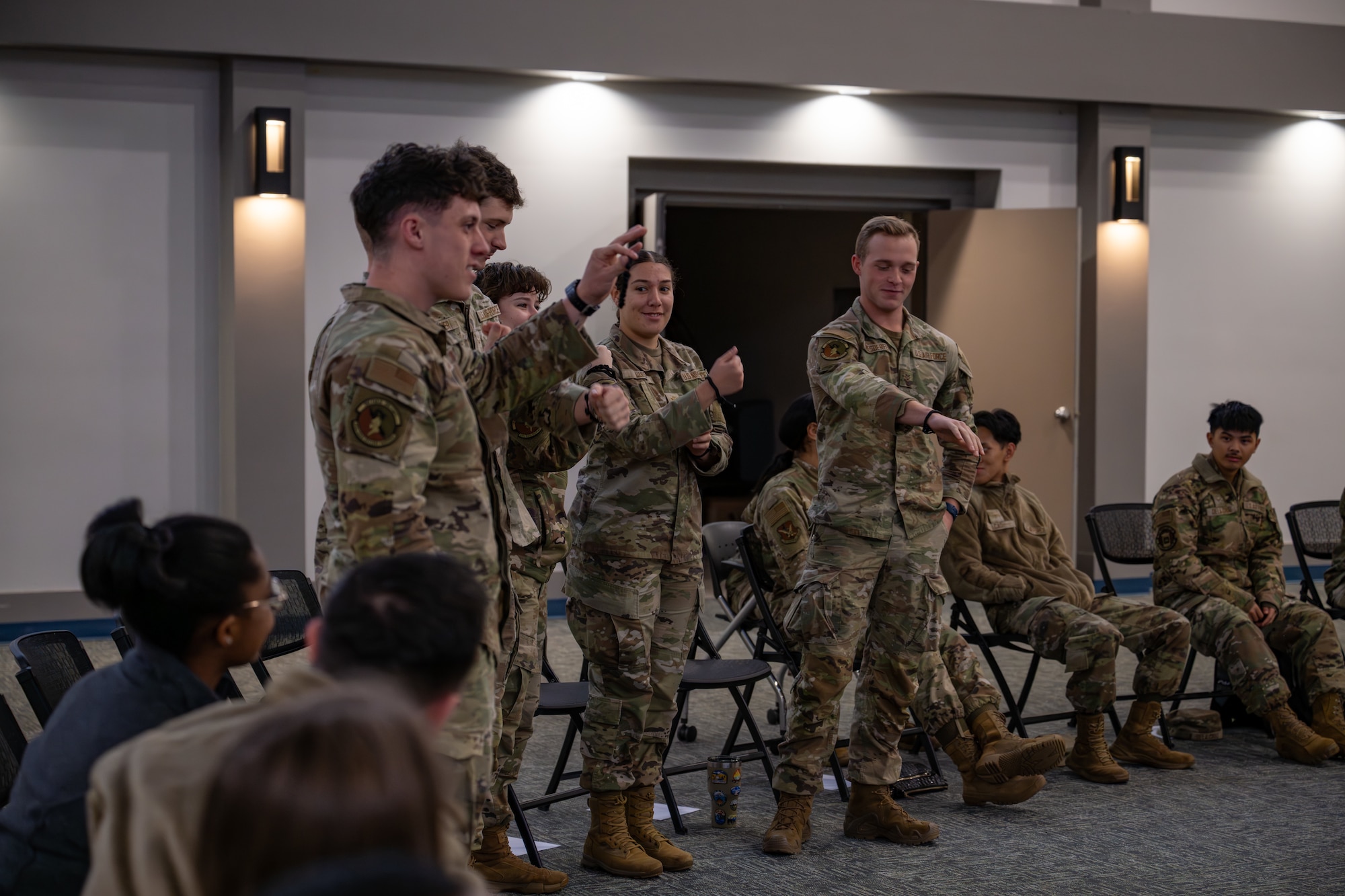 Group of people hold up bracelets.