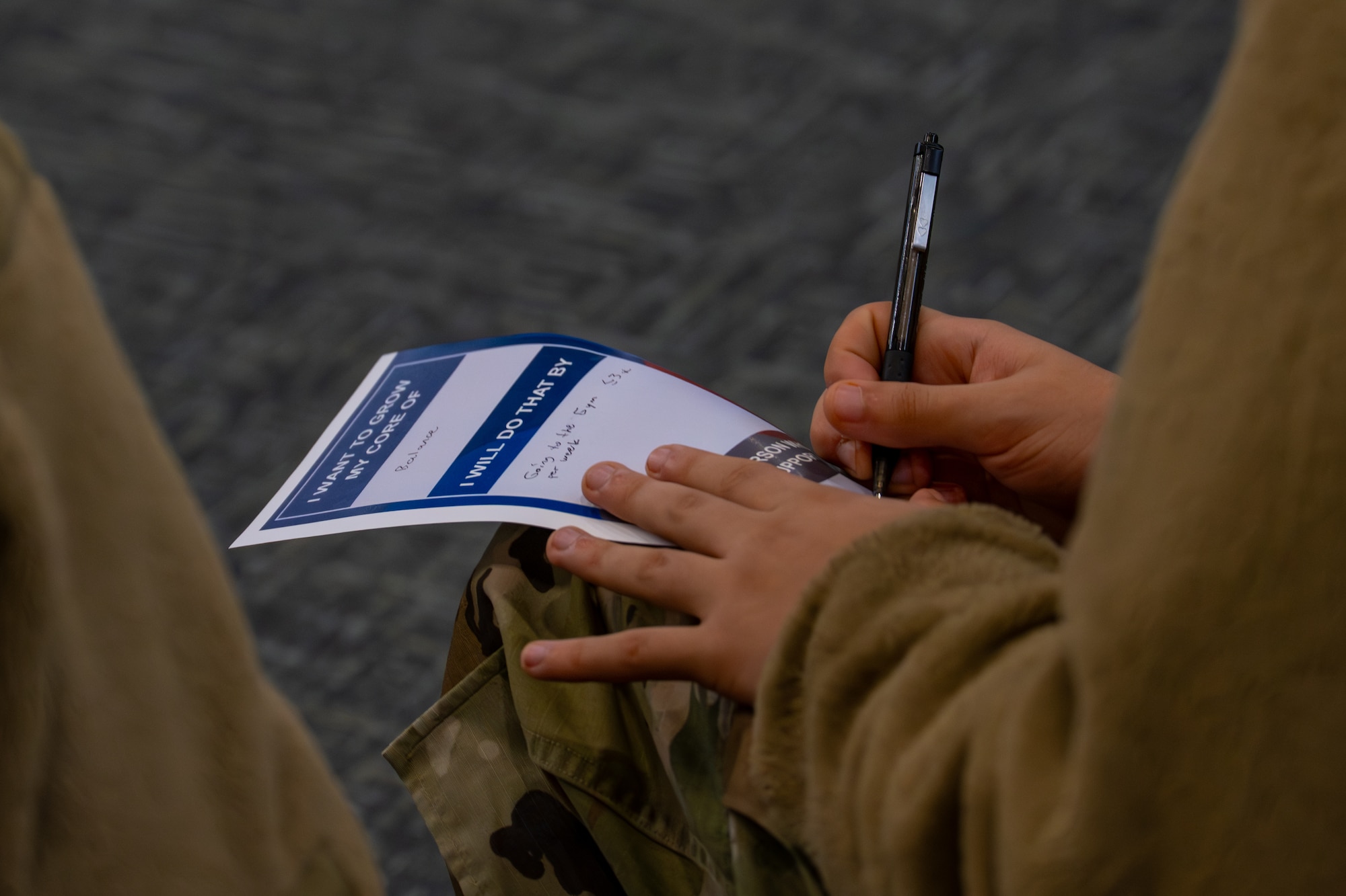 Hand writes on paper.