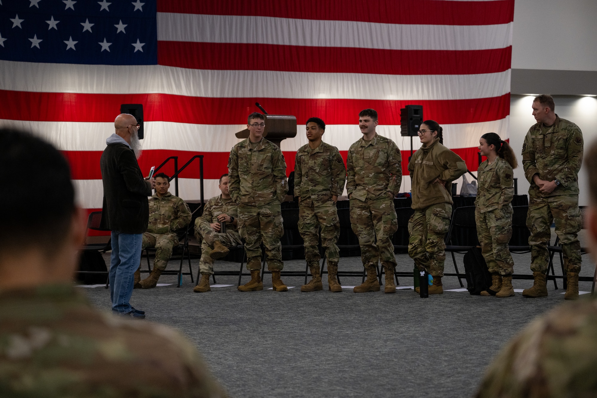 People in uniform stand in line.