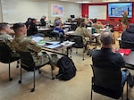 Wyoming National Guard Soldiers and partner firefighters participate in classroom instruction during the S-290 Intermediate Wildland Fire Behavior course at the Southeast Wyoming Wildland Academy. This training improves operational effectiveness by strengthening situational awareness and reducing risk during rapidly changing wildfire conditions. Photo by Maj. Craig Heilig.