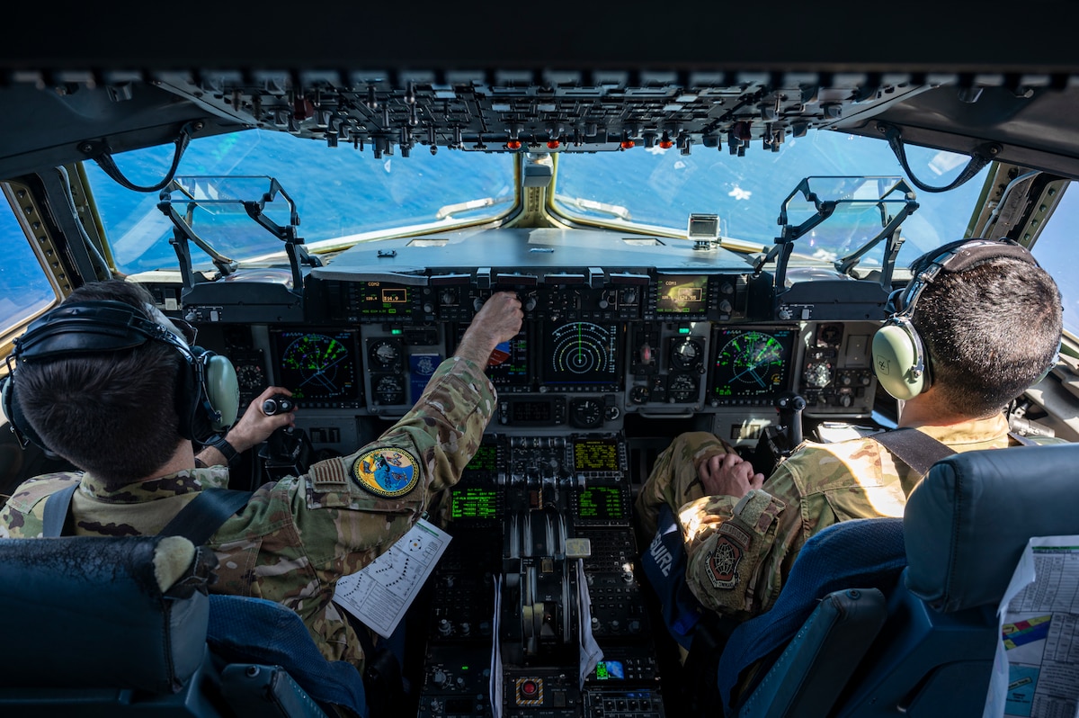U.S. Air Force Lt. Col Matthew Eggert, 6th Airlift Squadron commander, left, and Maj. Andrew Quallio, 6AS C-17 Globemaster III pilot, right, pilot a U.S. Air Force C-17 Globemaster III alongside USAF, U.S. Navy, Japan Air Self-Defense Force aircraft in a formation over the Pacific Ocean in support of Valiant Shield 2024, June 7, 2024. Exercises such as Valiant Shield allow the Indo-Pacific Command Joint Forces the opportunity to integrate forces from all branches of service and with our allies to conduct precise, lethal, and overwhelming multi-axis, multi-domain effects that demonstrate the strength and versatility of the Joint Force and our commitment to a free and open Indo-Pacific. (U.S. Air Force photo by Senior Airman Keegan Putman)
