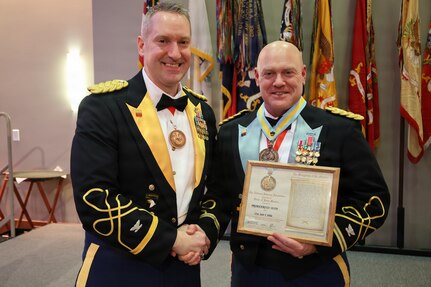 Col. Michael R. Kowalski presents Col. Seth Hibel with the Order of St. Maurice – Primicerius during the 33rd Infantry Brigade Combat Team military ball.