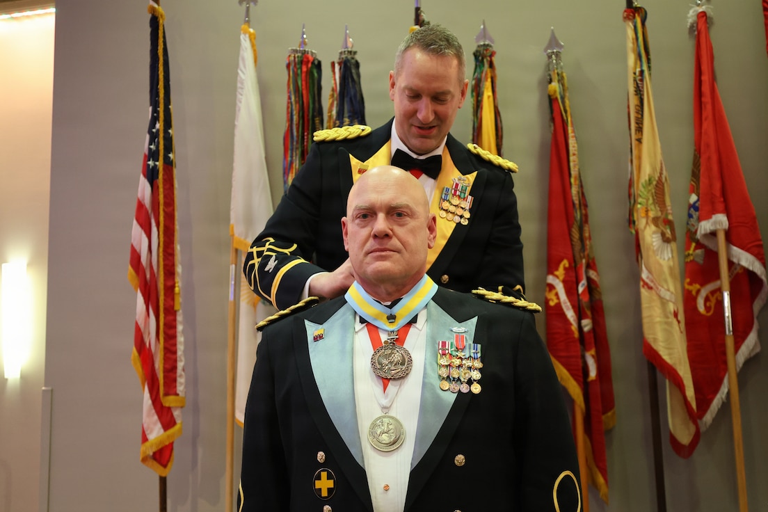 Col. Michael R. Kowalski presents Col. Seth Hibel with the Order of St. Maurice – Primicerius during the 33rd Infantry Brigade Combat Team military ball.