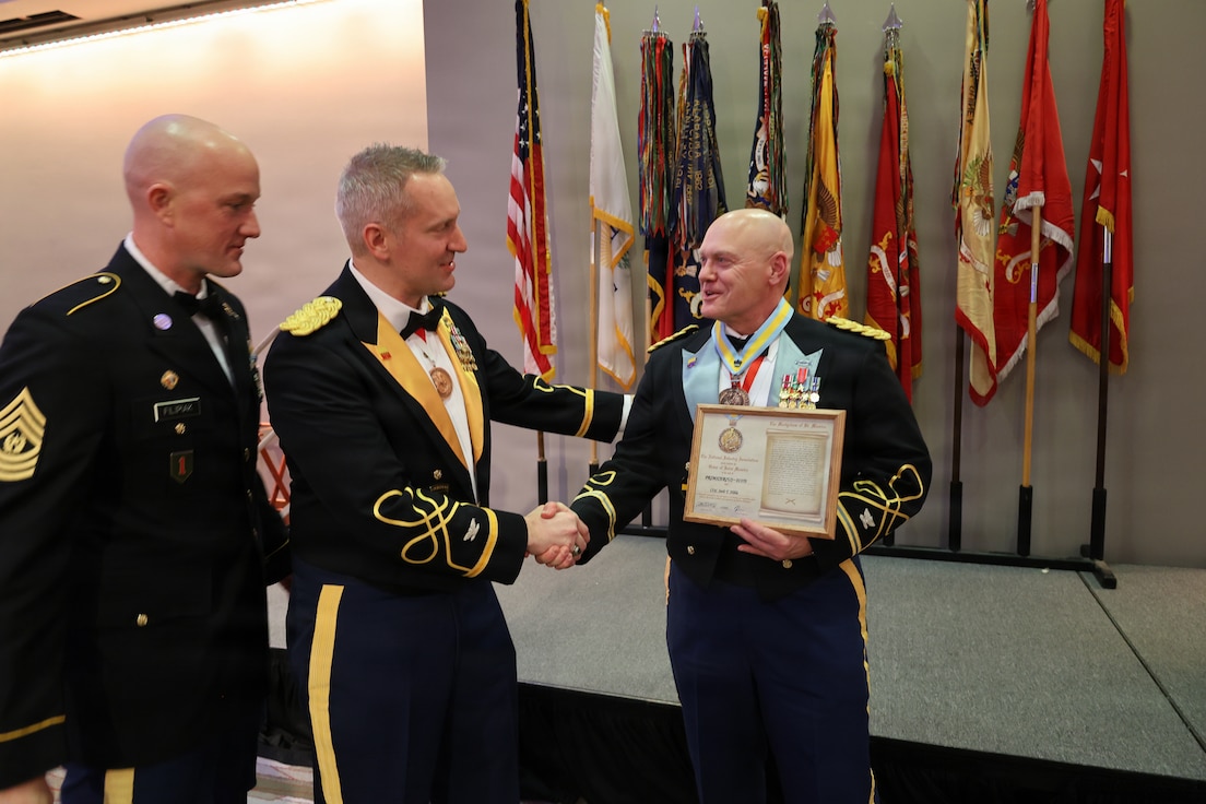 Col. Michael R. Kowalski presents Col. Seth Hibel with the Order of St. Maurice – Primicerius.