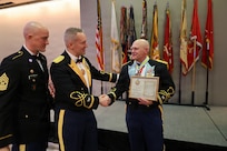 Col. Michael R. Kowalski presents Col. Seth Hibel with the Order of St. Maurice – Primicerius.