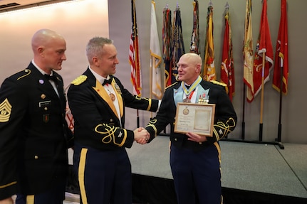 Col. Michael R. Kowalski presents Col. Seth Hibel with the Order of St. Maurice – Primicerius.