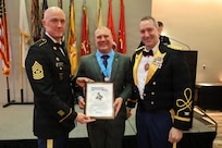 Brigade Command Sgt. Maj. Michael Filipiak and Col. Michael R. Kowalski, commander of the 33rd Infantry Brigade Combat Team, stand with Master Sgt. Aaron M. Bogacz after he received the Knowlton Award during the 33rd Infantry Brigade Combat Team military ball.