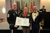 Capt. Devin J. Tegtman receives the Order of Samuel Sharpe during the 33rd Infantry Brigade Combat Team Military Ball, Feb. 7.