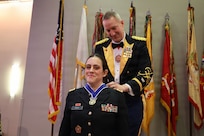 Col. Michael R. Kowalski presents Chief Warrant Officer 3 Jennifer M. Rosa with the Col. Robert L. Manning Achievement Medal.