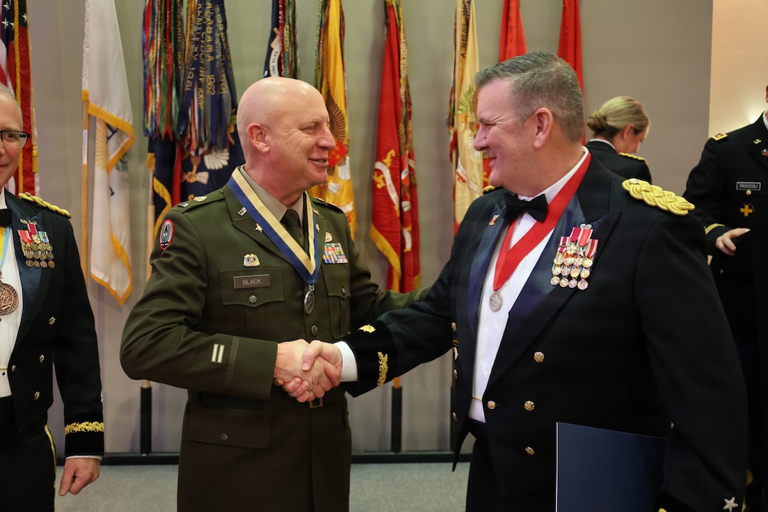 State Command Chief Warrant Officer Chief Warrant Officer 5 Thomas R. Black shakes hands with Assistant Adjutant General – Army and Commander of the Illinois Army National Guard Brig. Gen. Lenny Williams.
