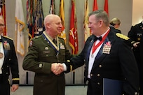 State Command Chief Warrant Officer Chief Warrant Officer 5 Thomas R. Black shakes hands with Assistant Adjutant General – Army and Commander of the Illinois Army National Guard Brig. Gen. Lenny Williams.