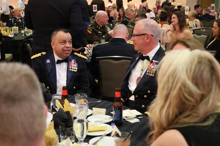 Brig. Gen. Jorge Fonseca speaks with Brig. Gen. Michael Eastridge at the 33rd Infantry Brigade Combat Team Ball.