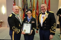 Col. Michael R. Kowalski and Col. Seth Hible present Chief Warrant Officer 3 Jennifer M. Rosa with the Col. Robert L. Manning Achievement Medal .