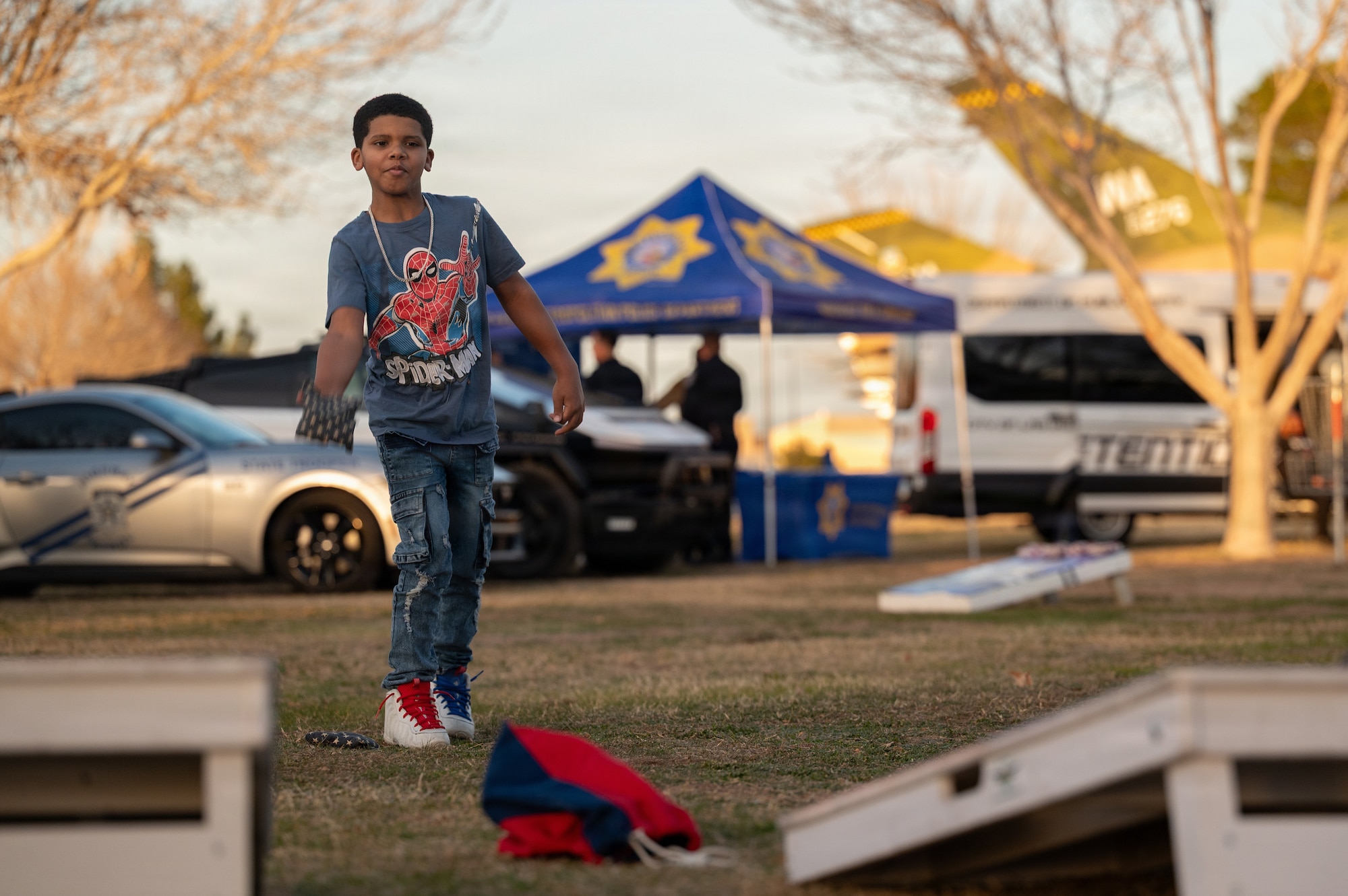 boy plays corn hole game