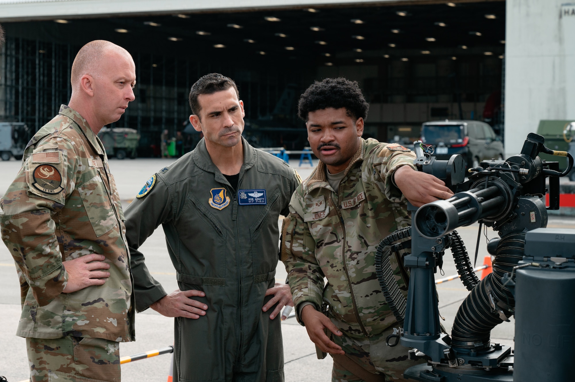 U.S. Air Force Col. Robert Arnett, center, 18th Wing deputy commander, and Chief Master Sgt. Keith Hodge, left, 18th Component Maintenance Squadron senior enlisted leader, observe Senior Airman Robert Jones, 33rd Rescue Generation Squadron weapons load crew member as he inspects an HH-60W Jolly Green II’s 7.62-mm mini-gun during the 18th Wing Load Crew of the Quarter Competition at Kadena Air Base, Japan, Jan. 30, 2026. Every quarter, the best weapons Airmen compete in a loading competition to find the most proficient crews and boost morale. (U.S. Air Force photo by Airman 1st Class Francisco Huerta)