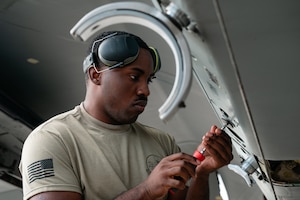 U.S. Air Force Senior Airman Elijah Armstrong, 67th Fighter Generation Squadron  
weapons load crew member, tightens a screw during the 18th Wing Load Crew of the Quarter Competition at Kadena Air Base, Japan, Jan. 30, 2026. These competitions ensure weapons systems are loaded accurately and efficiently, sustaining global strike readiness. (U.S. Air Force photo by Airman 1st Class Francisco Huerta)