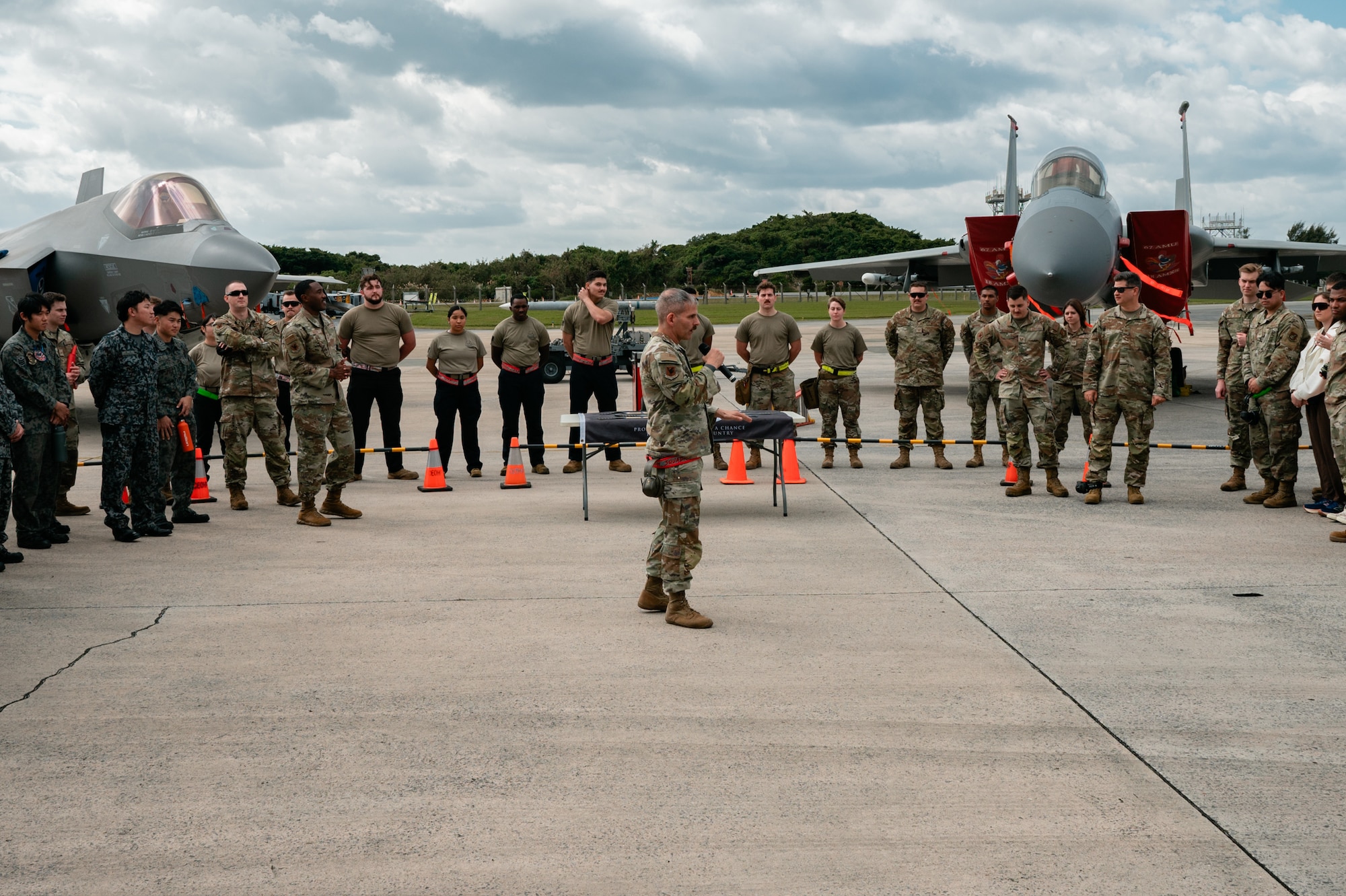 U.S. Air Force Chief Master Sgt. James Toombs, 18th Maintenance Group superintendent, announces the winners following the 18th Wing Load Crew of the Quarter Competition at Kadena Air Base, Japan, Jan. 30, 2026. The 18th Maintenance Group hosts weapons load competitions quarterly to enhance mission readiness and strengthen global strike capabilities. (U.S. Air Force photo by Airman 1st Class Francisco Huerta)