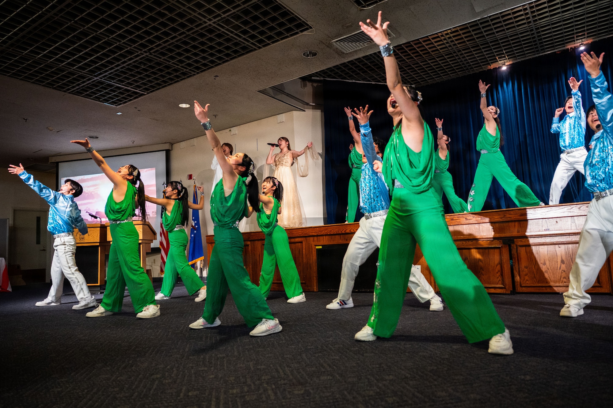 Performers in formation on stage