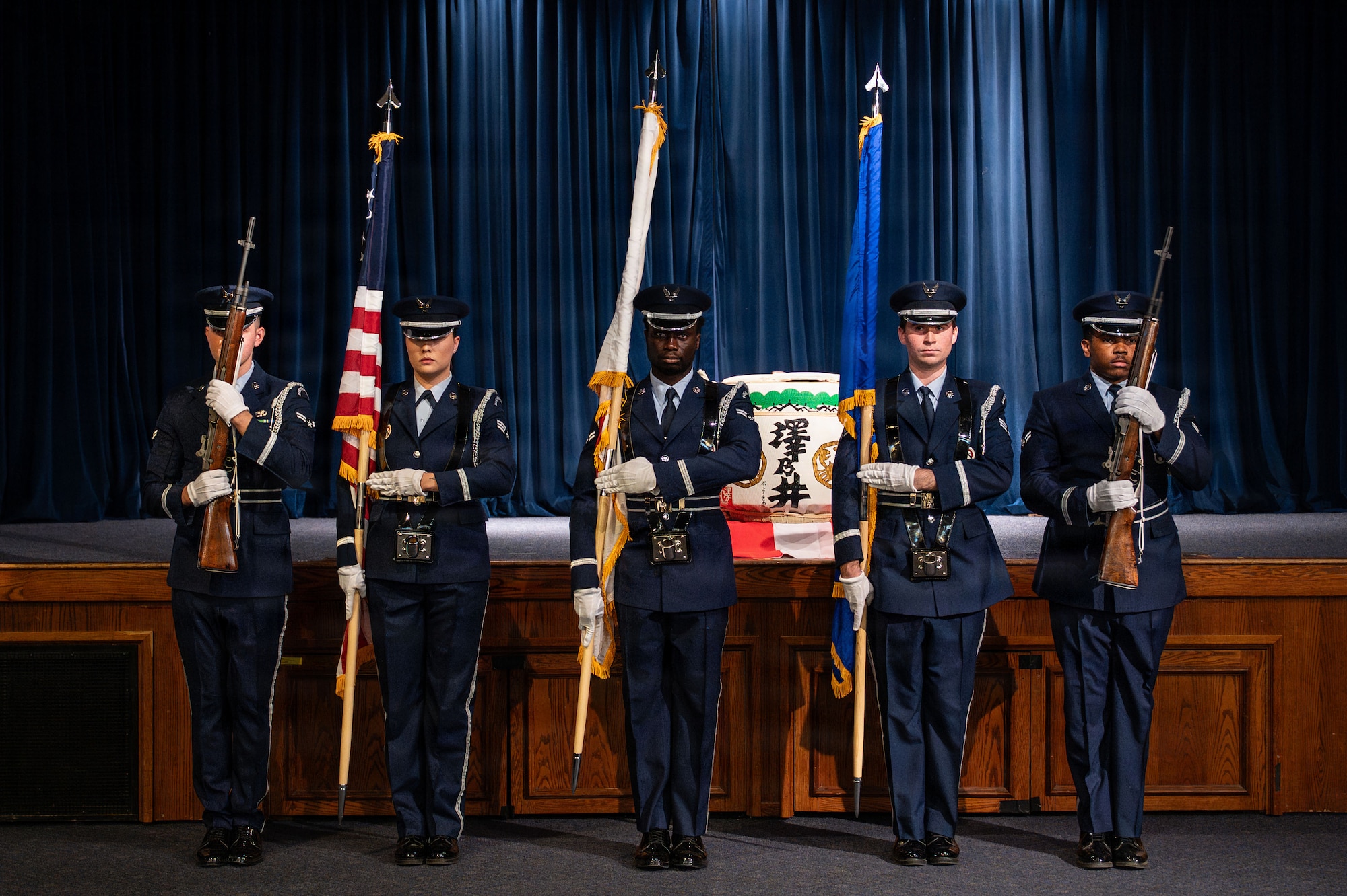 People holding flags and rifles in formation