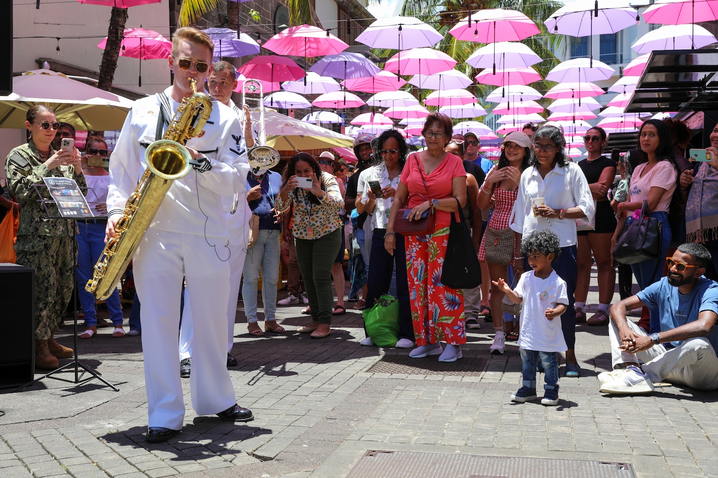 Musician 3rd Class Caleb Allen with the U.S. Naval Forces Europe and Africa Band (Topside Brass Band) plays at their performance at Caudan Waterfront (Umbrella Concert), Port Louis, Mauritius during Cutlass Express 2026 (CE 26).