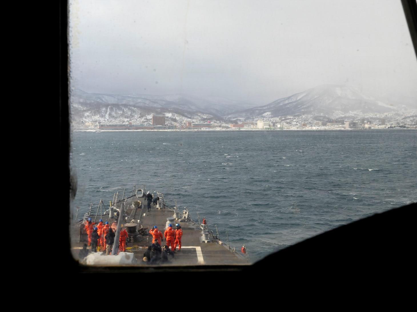 U.S. Navy Sailors take positions on the fo’c’sle as part of a sea and anchor detail aboard Arleigh Burke-class guided-missile destroyer USS Dewey (DDG 105) while conducting a port visit to Otaru, Japan, Feb. 6, 2026. Dewey is forward-deployed and assigned to Destroyer Squadron (DESRON) 15, the Navy’s largest DESRON and the U.S. 7th Fleet’s principal surface force. U.S. 7th Fleet is the Navy’s largest forward-deployed numbered fleet, and routinely interacts and operates with allies and partners in preserving a free and open Indo-Pacific region. (U.S. Navy photo by Mass Communication Specialist 2nd Class Oscar Diaz)